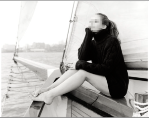 lady x sitting atop a sailor boat 