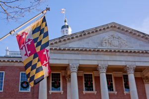 Close up view of Maryland state flag in front of the capitol state house in Annapolis, MD.